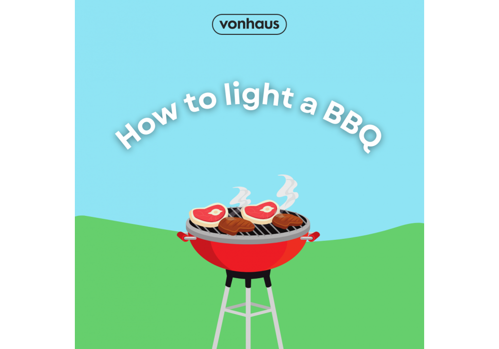 A red BBQ against a bright blue sky and green grass