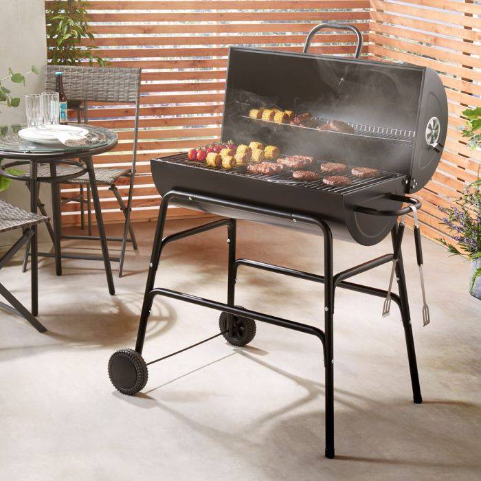 VonHaus barrel BBQ sizzling in garden