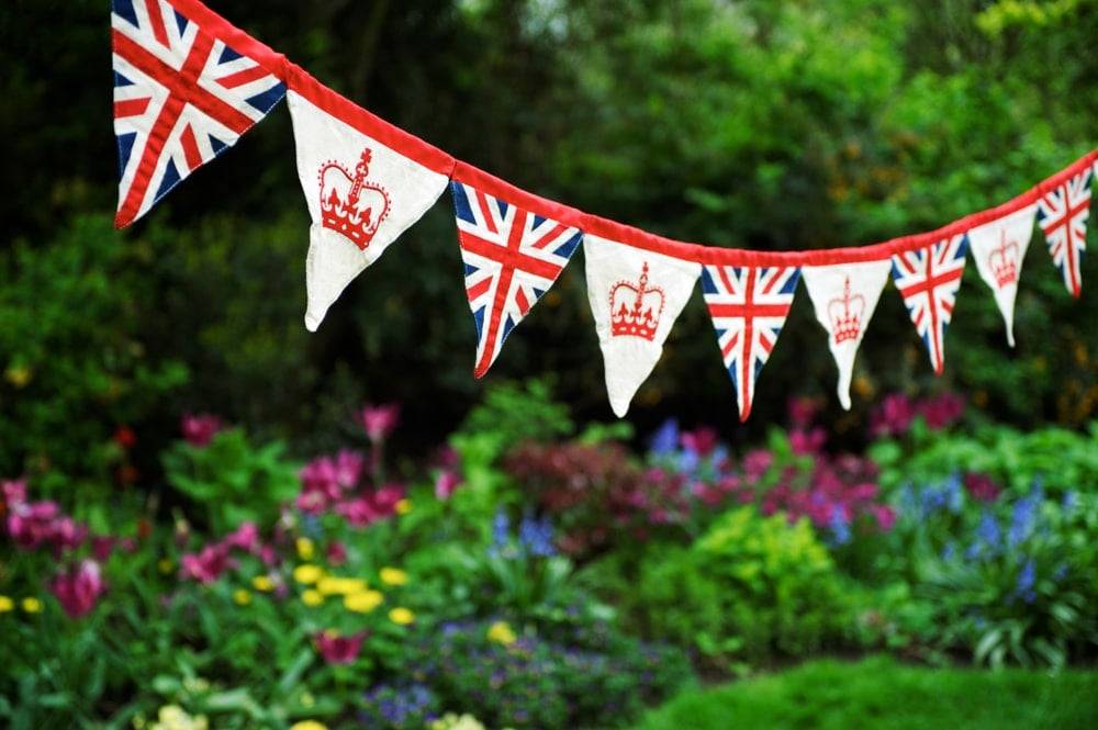 Queen's Platinum Jubilee bunting hung in a green garden