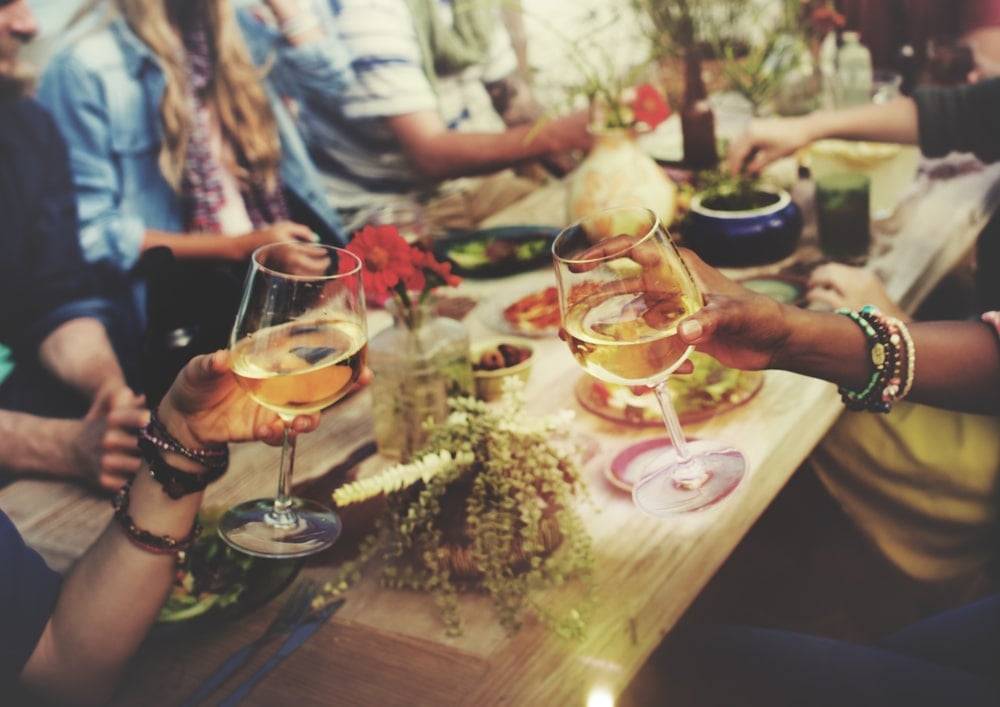 Close-up of adults dining outdoors