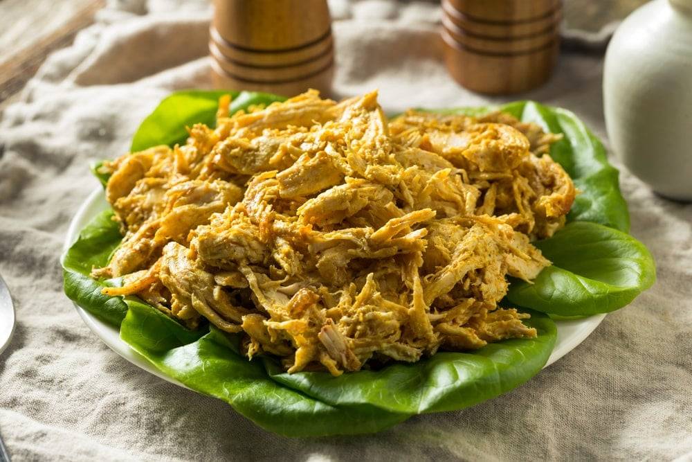 Coronation chicken dish on a bed of leafy vegetables