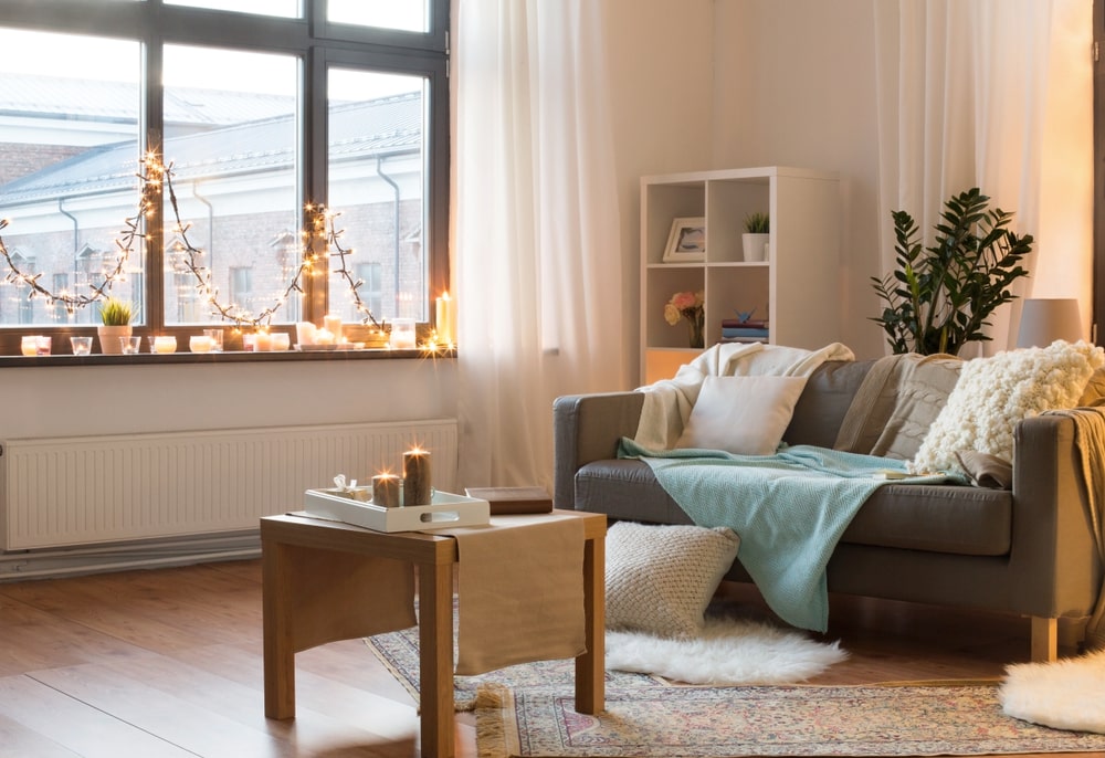 Cosy living room with vintage rugs and lights on windowsill