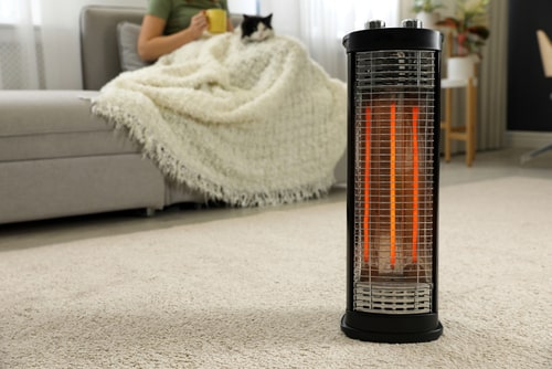 Close-up of halogen heater in a cosy living room