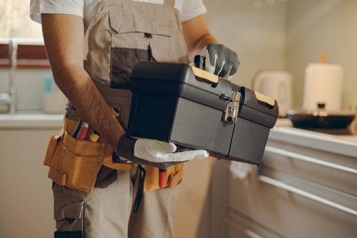 Handyman holding his toolbox