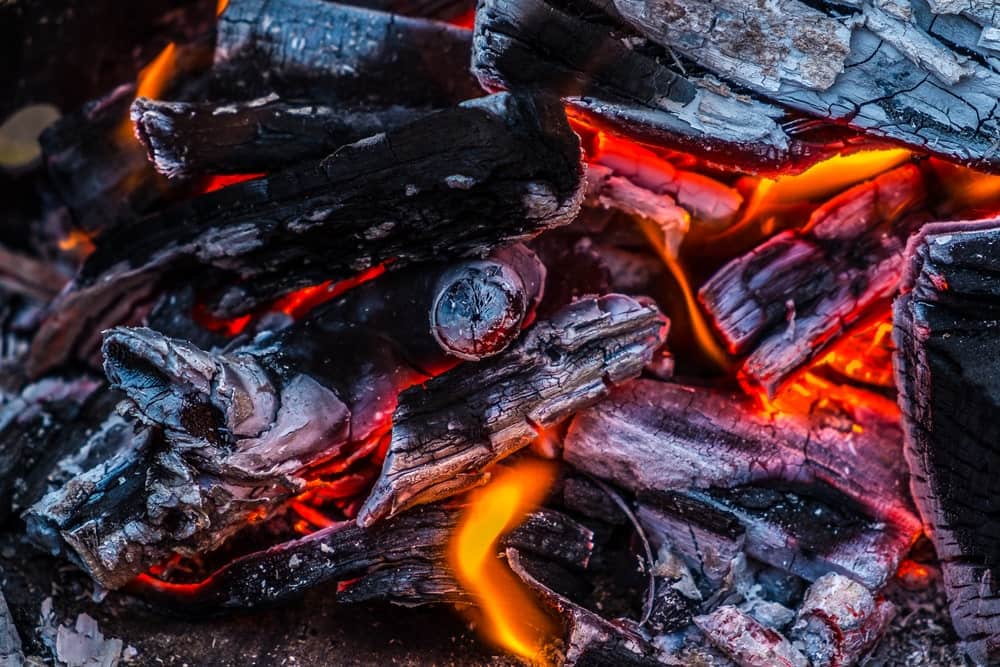 Smouldering lumpwood charcoal on a barbecue