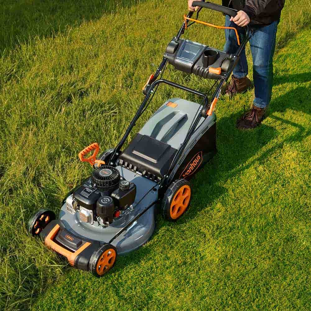 Man pushing Vonhaus petrol lawn mower