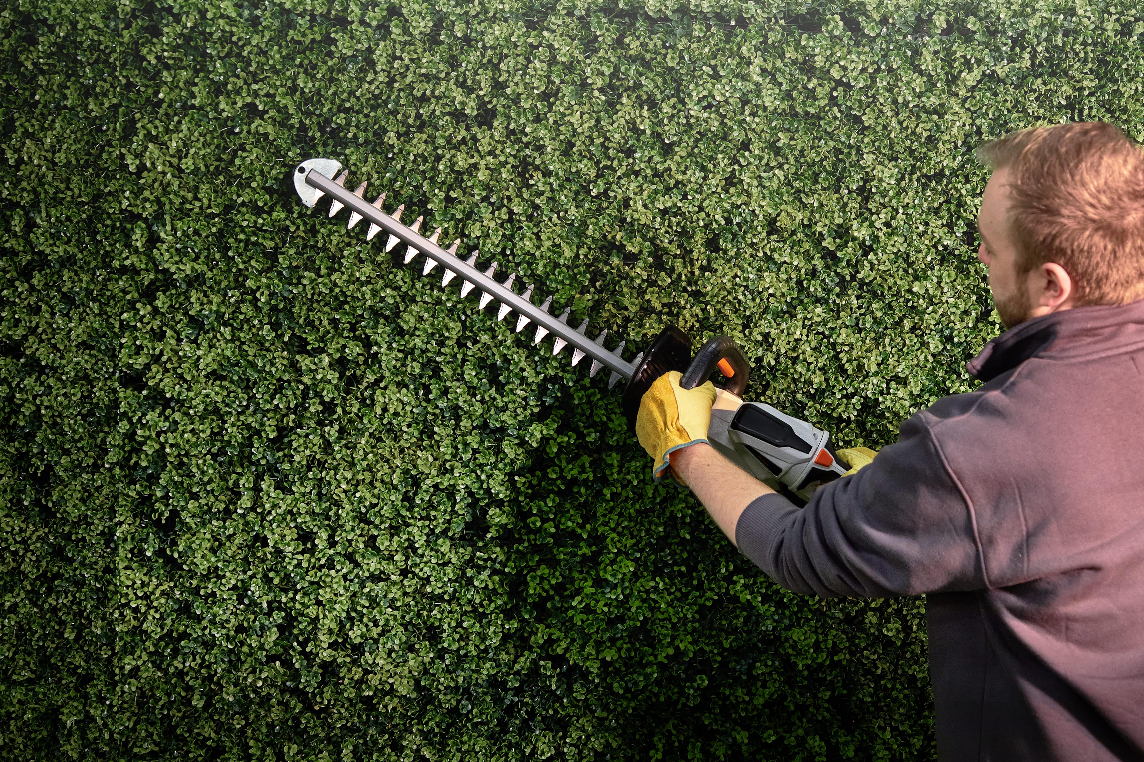 Man using VonHaus hedge trimmer