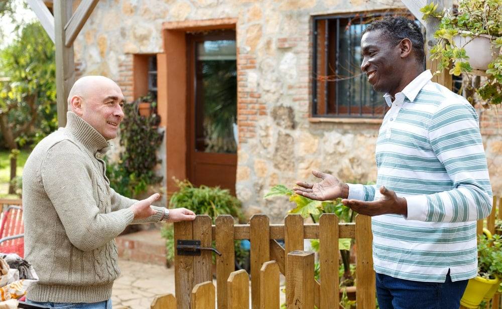 A man inviting his neighbour to his Platinum Jubilee party