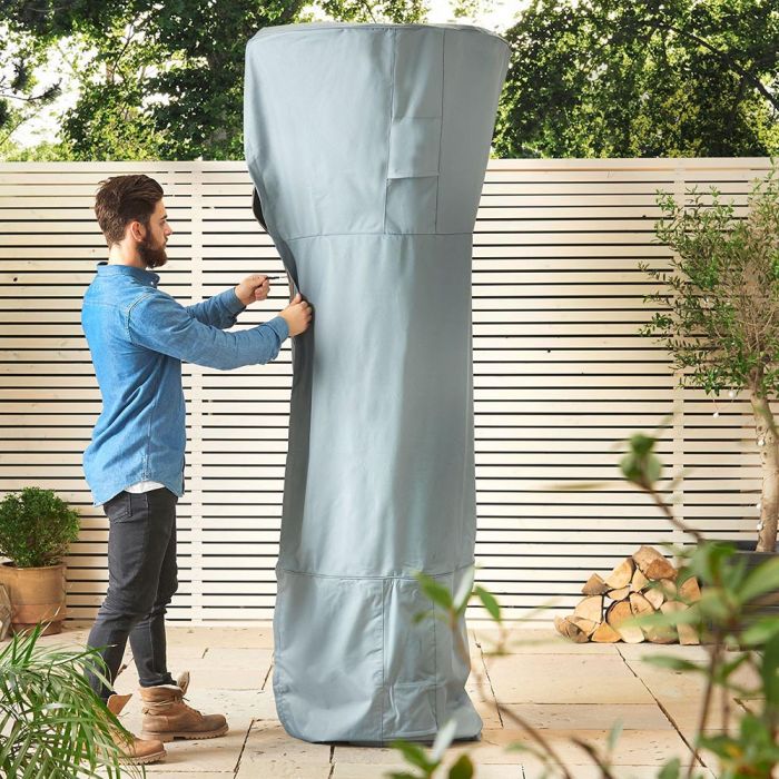 Man putting a waterproof cover on a heater