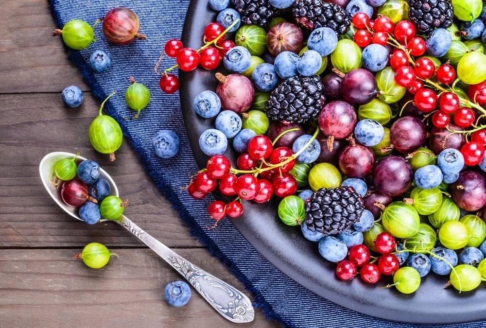 Plate of berries on a wooden table