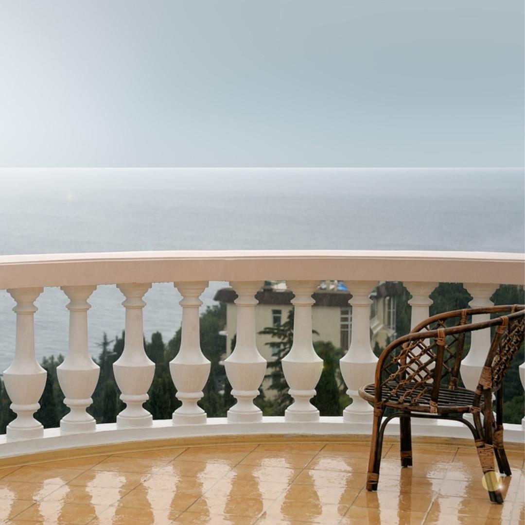 Rattan chair on a balcony in the rain