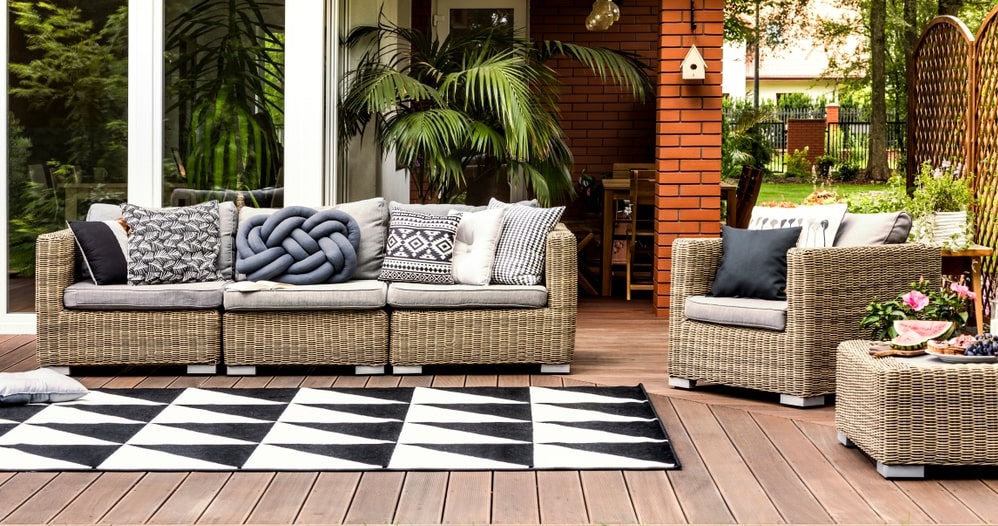 Decking with rattan sofa and bright cushions