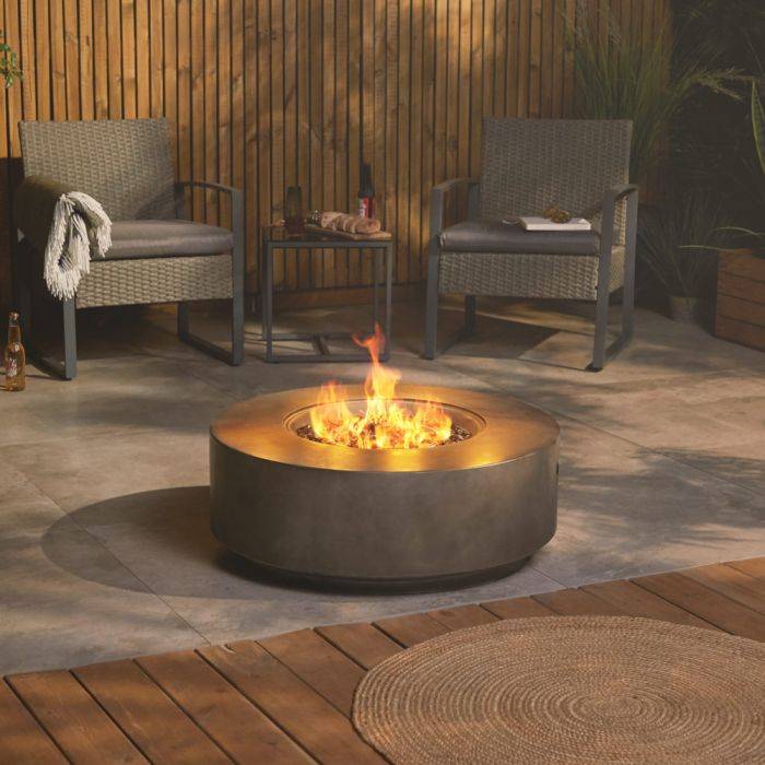 VonHaus round grey gas fire pit on a patio