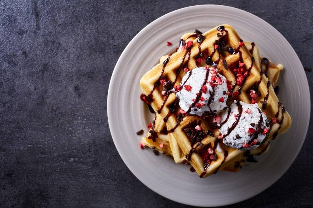 Belgian waffles drizzled with syrup