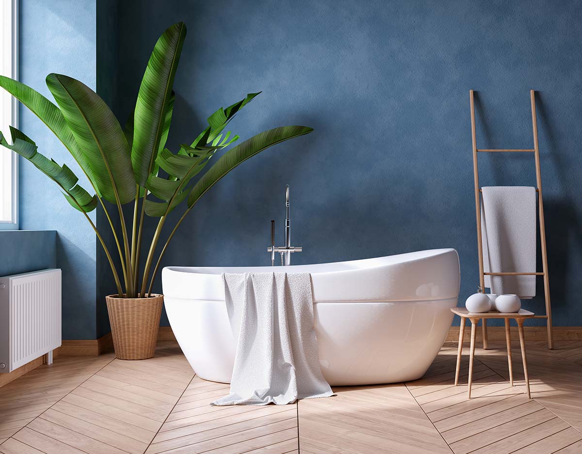 Serene blue bathroom with white freestanding bath