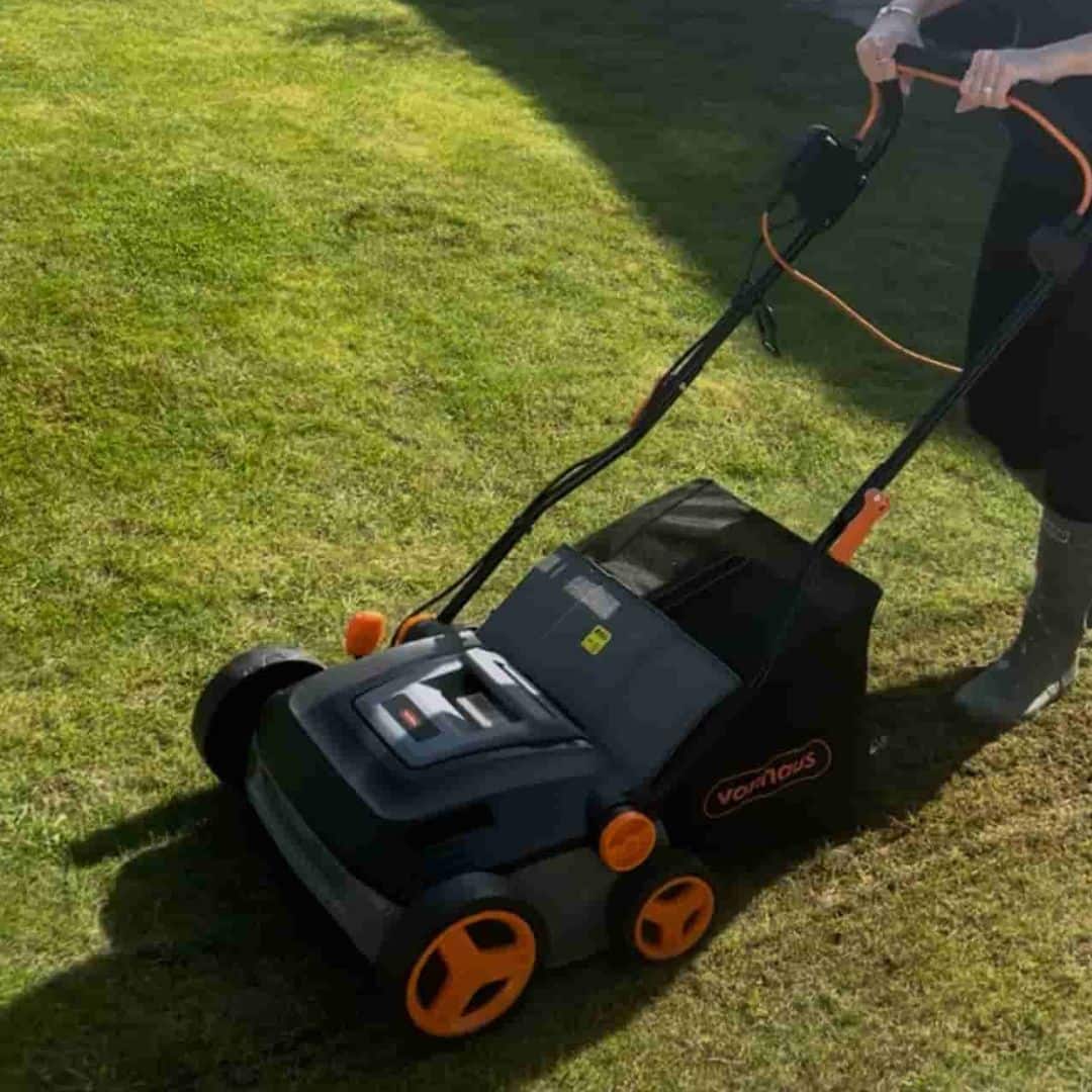Woman using Vonhaus scarifier in spring