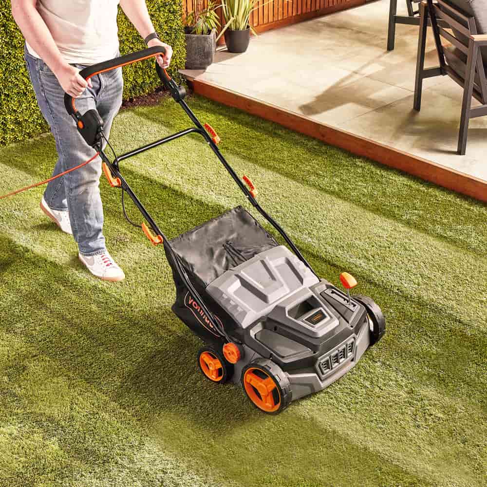 Woman using Vonhaus artificial grass brush