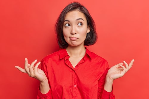 Young woman in red weighing up options
