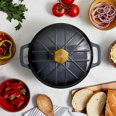 top down view of a black cast iron dish on a kitchen counter surrounded by food 