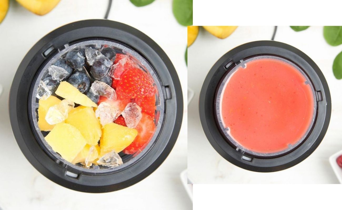 top down view of a red fruit smoothie in a black-rimmed blender