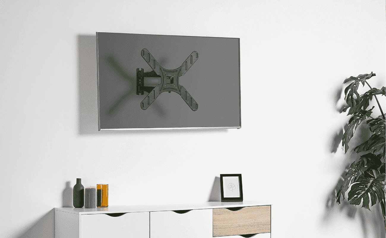 tv bracket on a white wall above a white sideboard