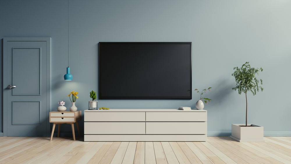 Wall-mouted TV in a light blue contemporary lounge